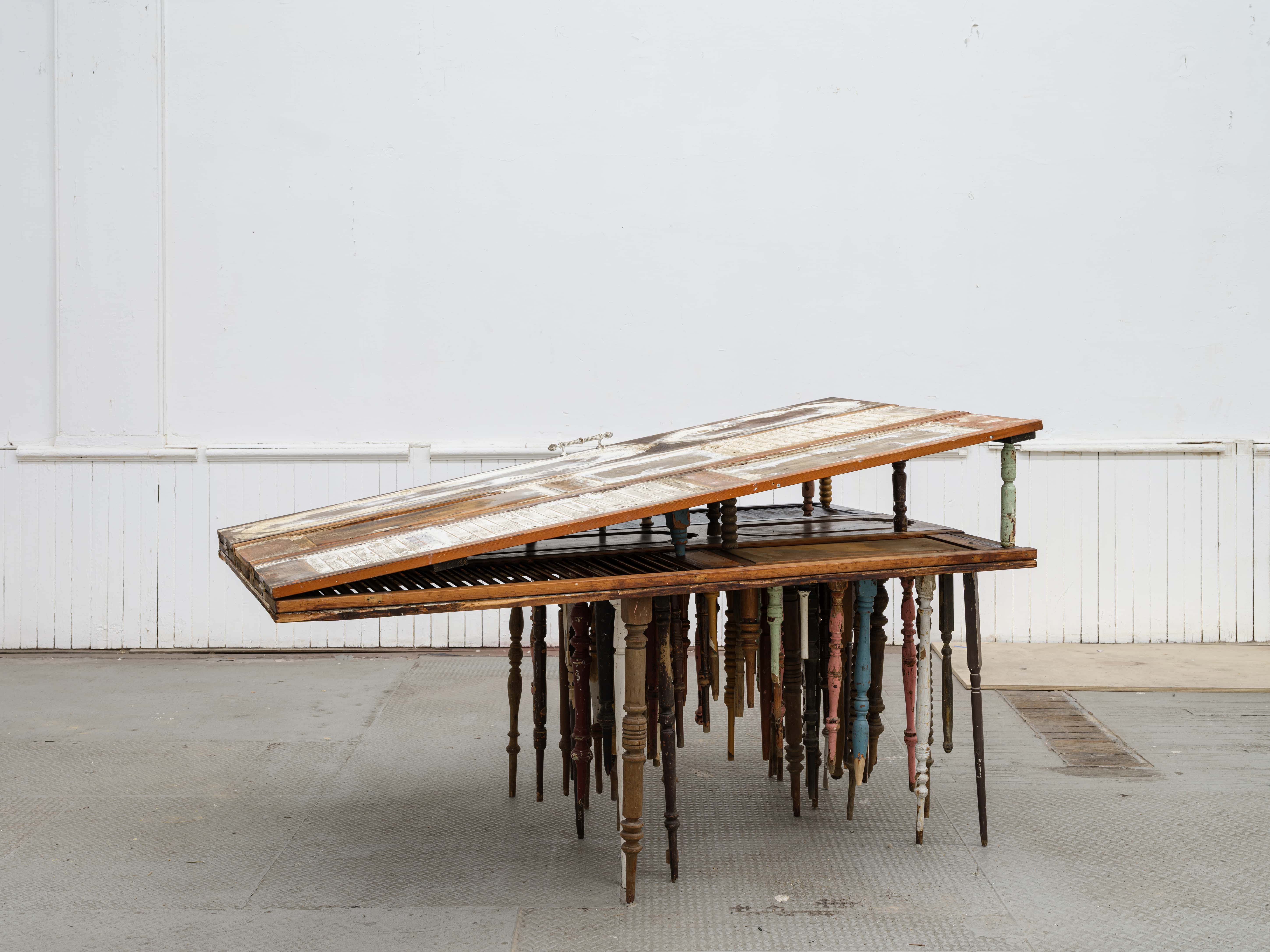 Mónica Mays, <i>The good the bad and the ugly</i>, 2026. Found wood shutters, found wood balusters, gesso, wax, stain, brass, 45 1/2 x 78 x 44 1/2 in (116 x 198 x 113 cm)
